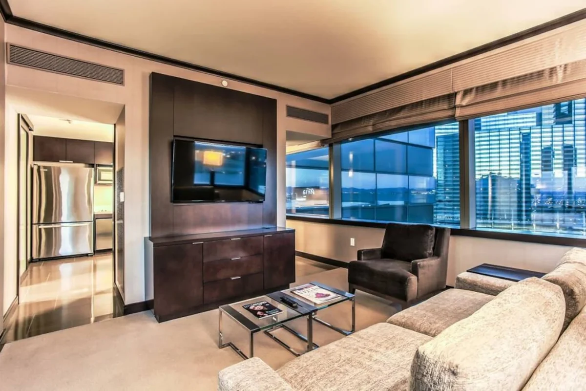 Las Vegas suite living room with a sectional sofa, television and floor-to-ceiling windows