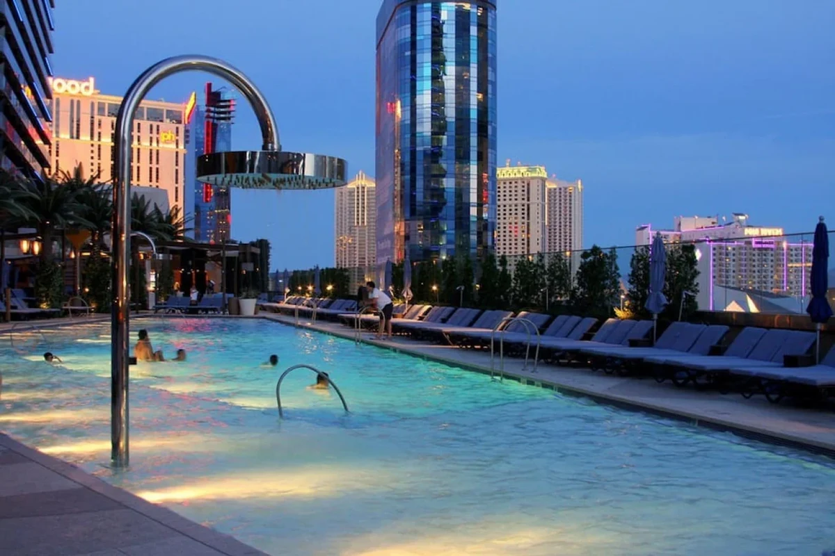 Las Vegas condo pool with loungers and high-rise buildings at dusk